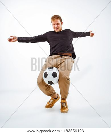 A portrait of a fan with ball on gray studio background. Freestile concept