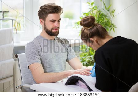 Close-up of man's hands at beautician's during manicure