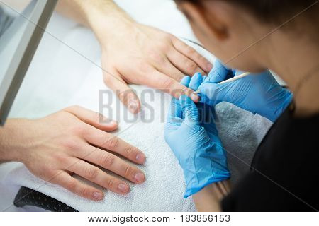 Close-up of man's hands at beautician's during manicure