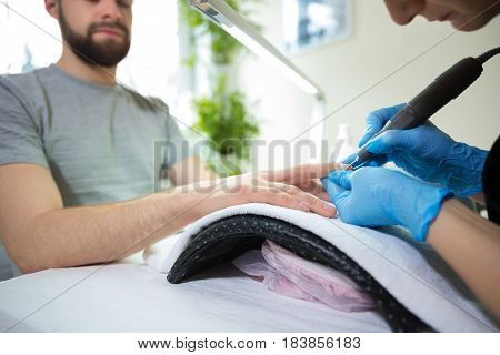 Close-up of man's hands at beautician's during manicure