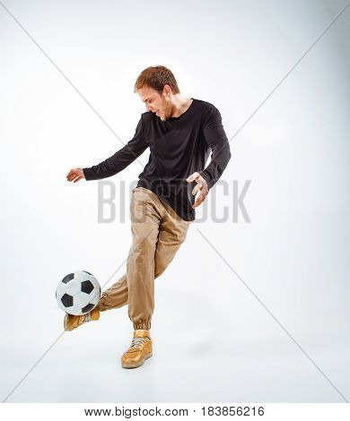 A portrait of a fan with ball on gray studio background. Freestile concept