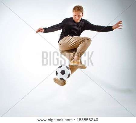 A portrait of a fan with ball on gray studio background. Freestile concept