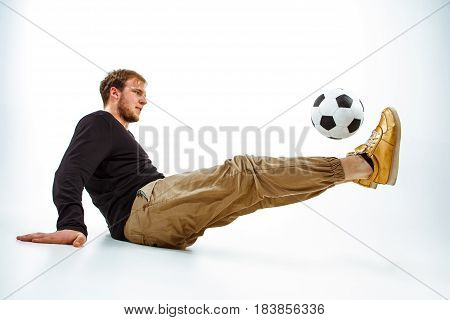 A portrait of a fan with ball on gray studio background. Freestile concept