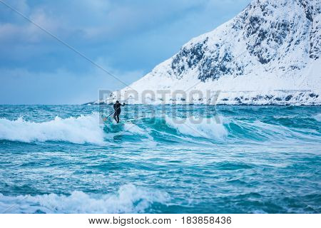 Flakstad Norway - March 18 2017: Surfer are training on the Skagsanden beach of the Lofoten Islands