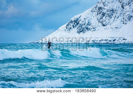 Flakstad Norway - March 18 2017: Surfer are training on the Skagsanden beach of the Lofoten Islands