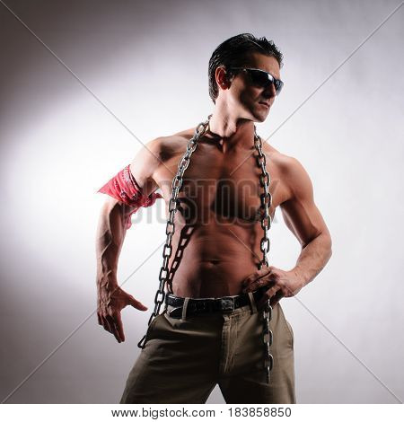 The sexy man is showing off his muscles.