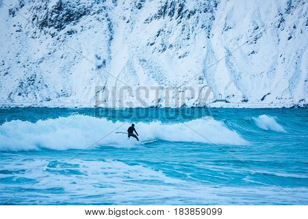 Flakstad Norway - March 18 2017: Surfer are training on the Skagsanden beach of the Lofoten Islands