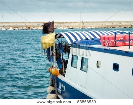 Oneglia Italy - June 14 2015: Marina and fishing. Several fishing boats are moored. In the background the buildings typical of Oneglia.