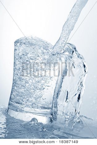 water running into a glass isolated on white