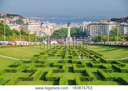 Hedge maze park forming a long perspective to Marquis of Pombal square in Lisbon, Portugal