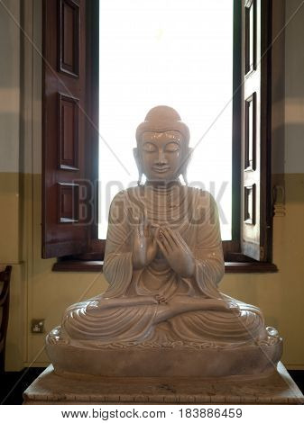 Buddha statue with a opened window backround