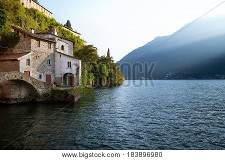 Old stone bridge at the end of Nesso's ravine Como Italy