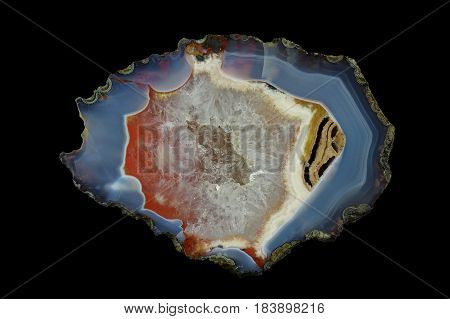 A cross section of the agate stone with quartz geode. Multicolored silica rings colored with metal oxides are visible. Origin: Asni Atlas Mountains Morocco.