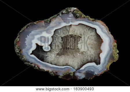 A cross section of the agate stone with quartz geode. Multicolored silica rings colored with metal oxides are visible. Origin: Asni Atlas Mountains Morocco.