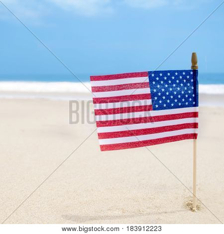 Independence Day USA background with flag on the sandy beach near the ocean American patriotic concept square Instagram format
