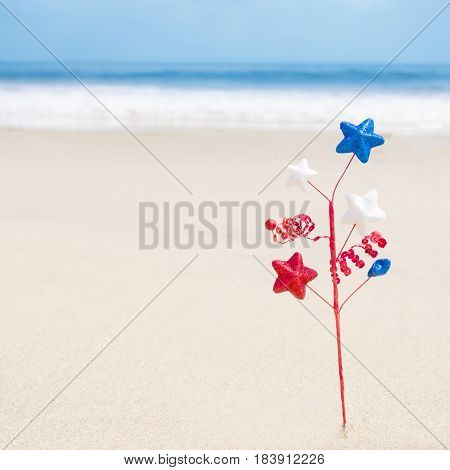 Independence Day USA background with decoration on the sandy beach near the ocean American patriotic concept square Instagram format