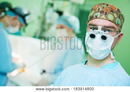male cardiac surgeon at child cardiosurgery operating room