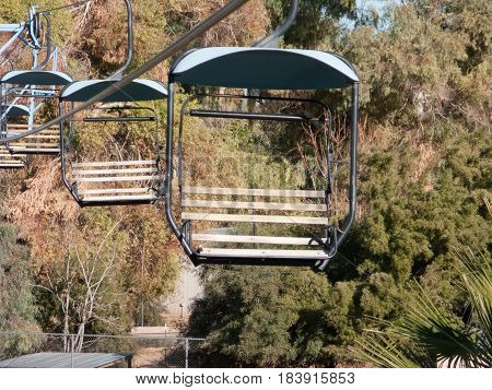 Riding high above tree line in open cabins