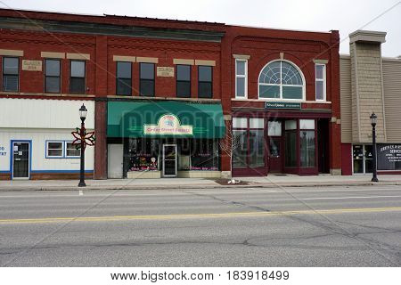 KALKASKA, MICHIGAN / UNITED STATES - NOVEMBER 27, 2016: Two of the principal businesses in downtown Kalkaska include the Cedar Street Sweets Bakery and Edward Jones Investments.