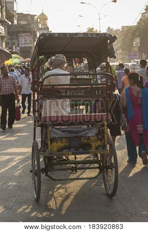 DELHI INDIA - JUN 6 : rickshaw driver in crowded of people at chandni chowk in old Delhi of Delhi on june 6 2015 india. rickshaw is three wheeler taxi of Delhi