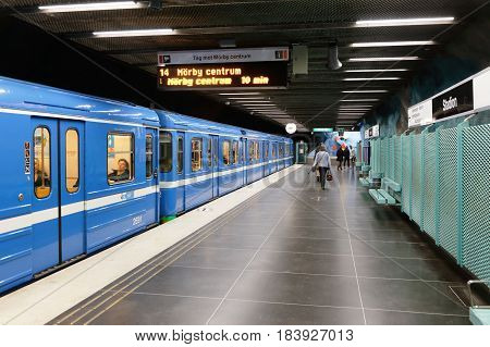 Stockholm Sweden April 23 2014: A blue metro train with closed doors on line 14 towards Morby center is ready for departure fromthe undrground station Stadion.