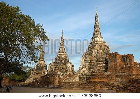 Three ancient stupas of the Buddhist temple of Wat Phra Si Sanphet on a cloudy morning. Ayutthaya, Thailand