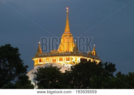 Chedi Temple of the Golden Mountain (Wat Sacket) in the evening twilight close up. Bangkok, Thailand