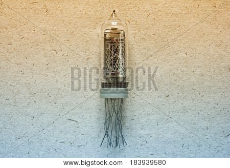 Top view of nixie tube indicator of the numbers retro style on kraft paper background in bi colors.