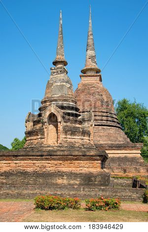 Two ancient chedi of Buddhist temple Wat Sa Si. Sukhothai Historical Park Thailand