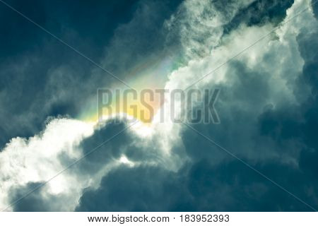 Amazing rainbow on white and dark cloud before raining.