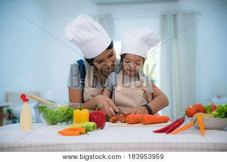 Mother and daughter cooking togather for making salad and prepare vegetable in kitchen room