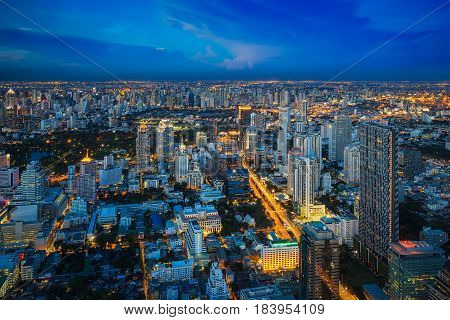 Rooftop viewpoint from Mahanakorn building see Bangkok city lumpini park Silom and cityscape on blue sky time Bangkok Thailand. Photo include space at sky for put your text