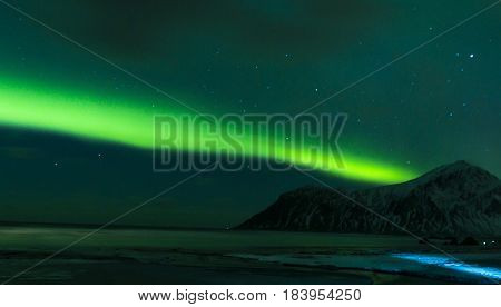 Aurora Borealis Known as Nother Lights Playing with Vivid Colors Over Lofoten Islands in Norway. Horizontal Image Orientation
