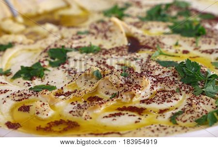 Hummus With Olive Oil And Parsley In A Bowl