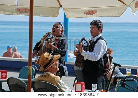 TORROX COSTA, SPAIN - OCTOBER 27, 2008 - Musicians performing outside a pavement cafe along the promenade Torrox Costa Malaga Province Andalusia Spain Western Europe, October 27, 2008.