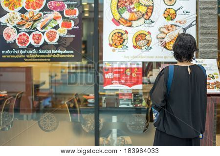 Asia Women Stand At Front Of Barbecue Restaurant