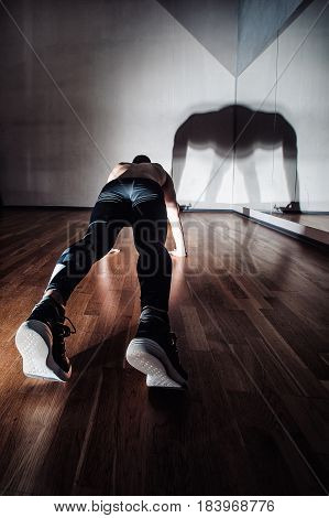Attractive Muscular Man Doing Push-ups On A Wooden Floor.