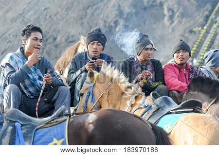 Horse Riders Smoking Cigarettes On Mt.bromo National Park