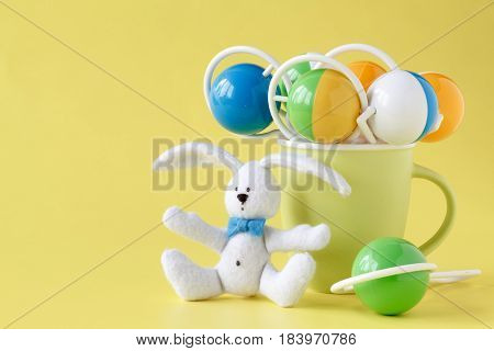 Classic Rattle Toy With Rabbit  On Yellow Background