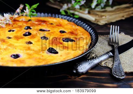 cottage cheese casserole with blueberries  in a cast iron form