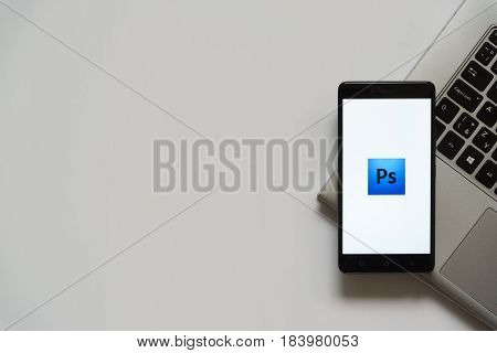 Bratislava, Slovakia, April 28, 2017: Adobe photoshop logo on smartphone screen placed on laptop keyboard. Empty place to write information.