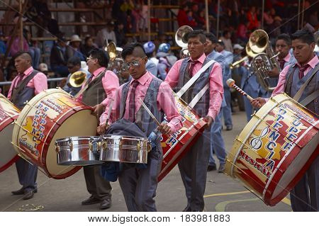 ORURO, BOLIVIA - FEBRUARY 26, 2017: Band of a Morenada dance group in colourful outfits parading through the mining city of Oruro on the Altiplano of Bolivia during the annual Oruro Carnival.