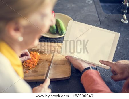 Senior Woman Cooking Food Kitchen Tablet