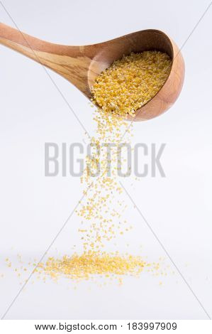 Wheat Groats. Spoon Of Wheat Groats Falling On A White Background