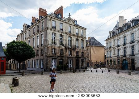 Rennes, France - July 23, 2018: Woman With Smartphone In Square In Historic Centre Of The City. Renn