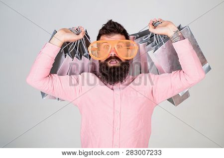 How To Get Ready For Your Next Vacation. Man Bearded Hipster Wear Sunglasses While Carry Lot Shoppin