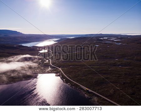Aerial View. Road Crossing Hardangervidda Mountain Plateau, Clouds Over Lakes, Morning Time. Norway 