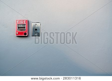 Fire Alarm On White Concrete Wall. Warning And Security System. Emergency Equipment For Safety Alert