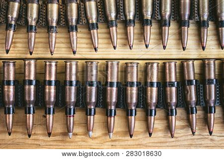 Machine Gun Ammo On A Wooden Table, Bullet Belt, Bandoleer, Chain Of Ammo On Wooden Background,cartr