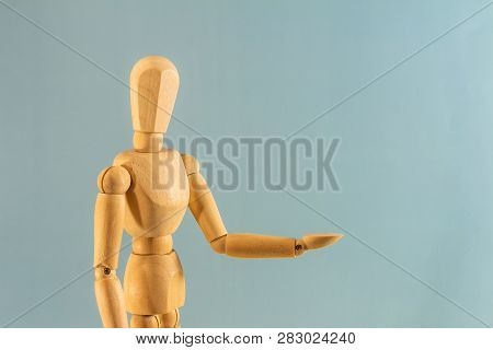 Wooden Doll As A Model For Drawing On A Neutral Background. Concept Of Asking For Help, Sadness, Lon